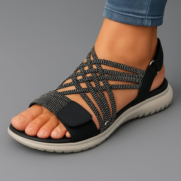 Black orthopaedic sandals with woven striped upper, open toe and cushioned sole.