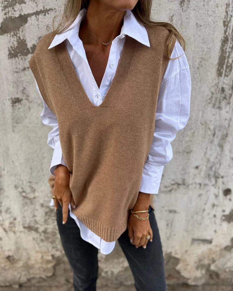 Brown knit sweater vest over a white button-down, V-neck and sleeveless design.