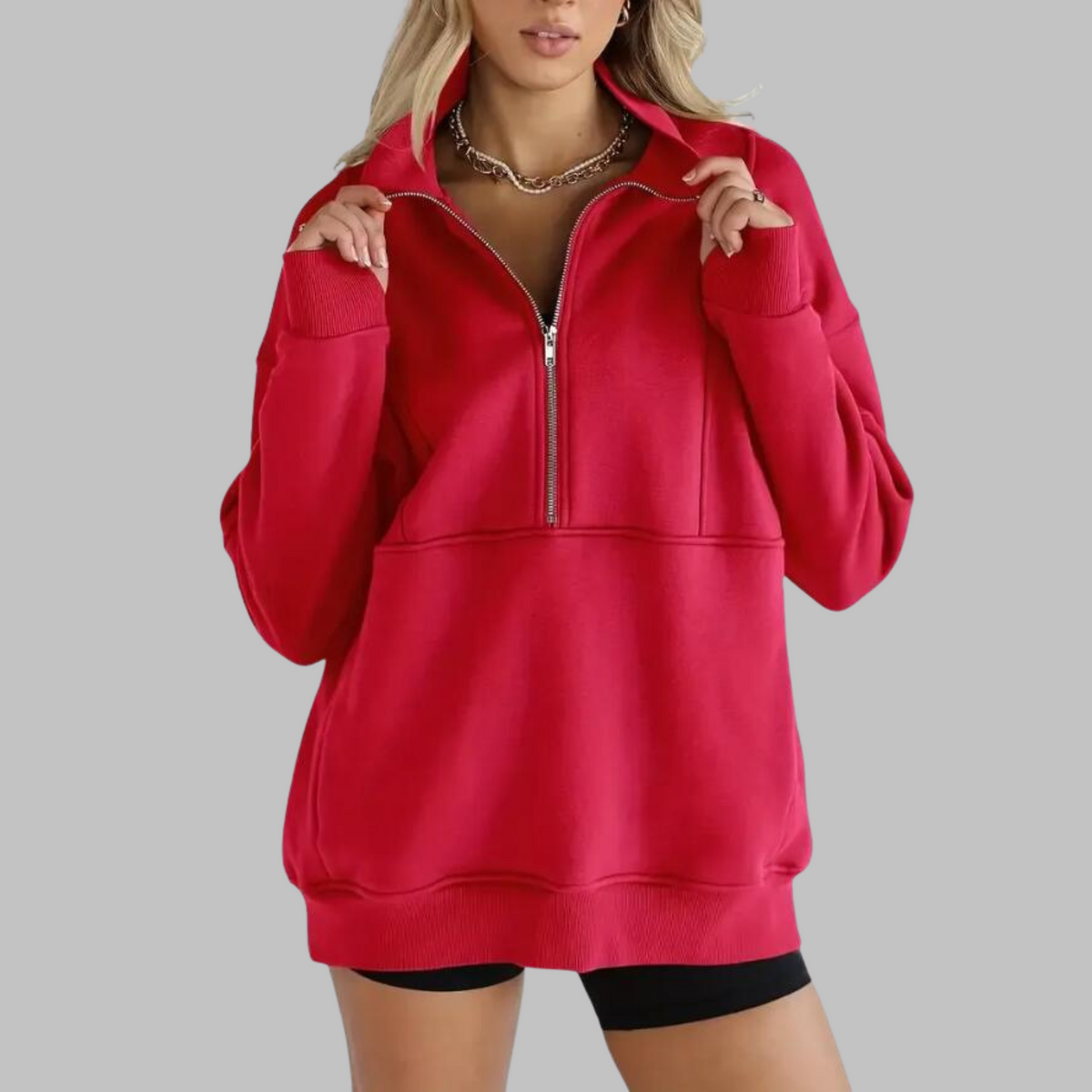 Red oversized half-zip long sleeve sweatshirt with ribbed cuffs, collar, and front pocket