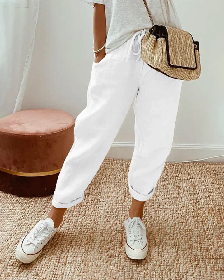 White retro-style pants with relaxed fit and ankle-length cuffs