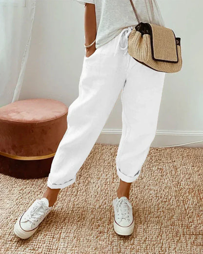 White retro-style pants with relaxed fit and ankle-length cuffs