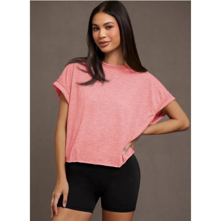 Pink women’s cut out hemline short-sleeve top, crew neck, relaxed drape