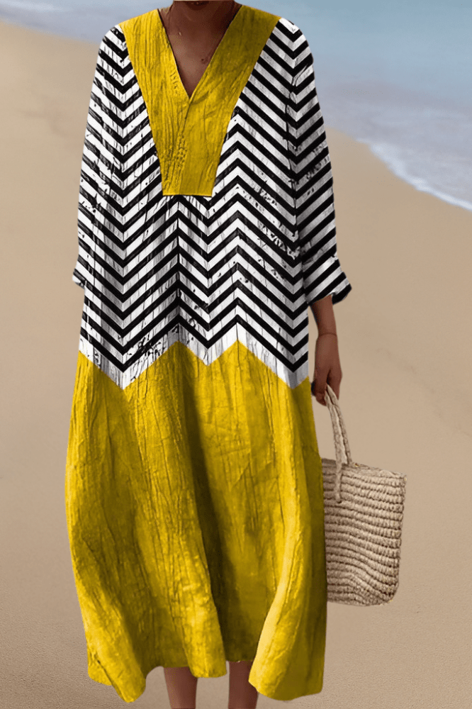 Sunburst Rhythm dress with yellow V-neck yoke, black-and-white chevron sleeves, maxi skirt