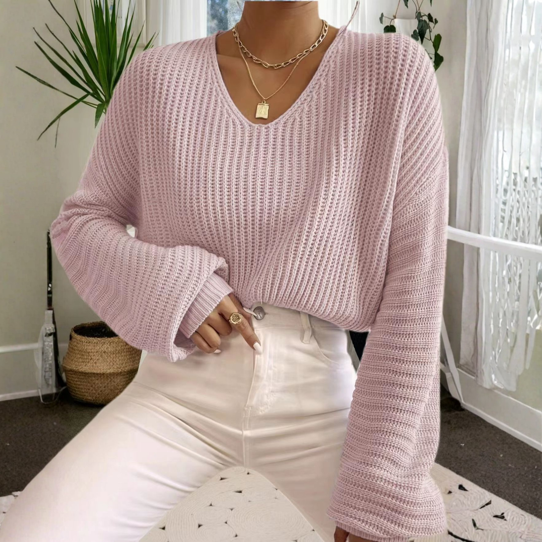 Pink knit V-neck long-sleeve sweater with ribbed cuffs and textured stitch
