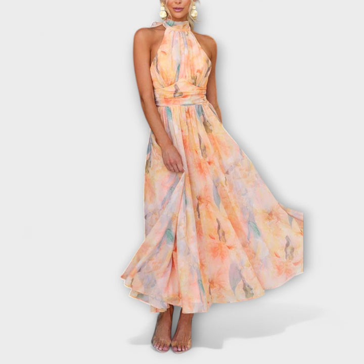 Maxi dress front view with halter neck, sleeveless pastel floral print, flowing skirt