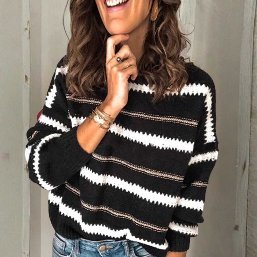 Crewneck sweater with long sleeves; black knit with white and tan horizontal stripes.