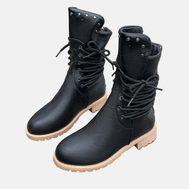 Black mid-length lace-up walking boots with metal stud accents and textured rubber sole