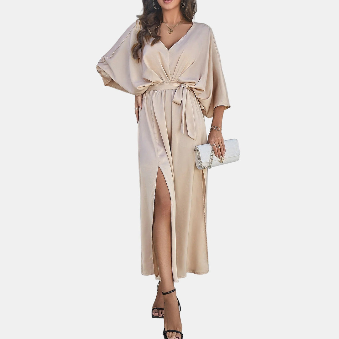 Beige elegant maxi dress with V-neck, tie waist, flowing sleeves and thigh-high slit