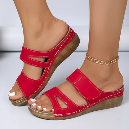 Red ergonomic sandals with dual straps and open toe, cushioned tan sole