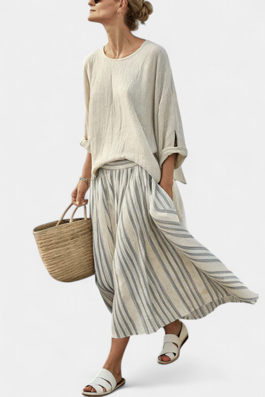 Cream blouse with three-quarter sleeves and gray-and-white striped midi skirt