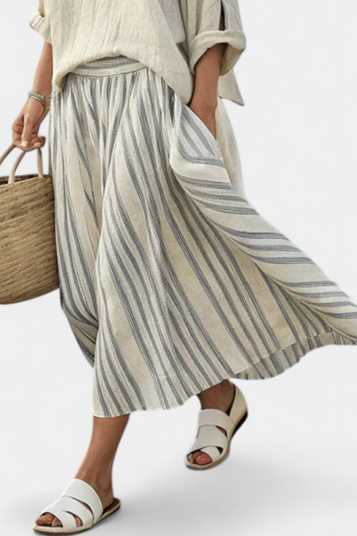Gray-and-white striped midi skirt with gathered waist and flowy pleats