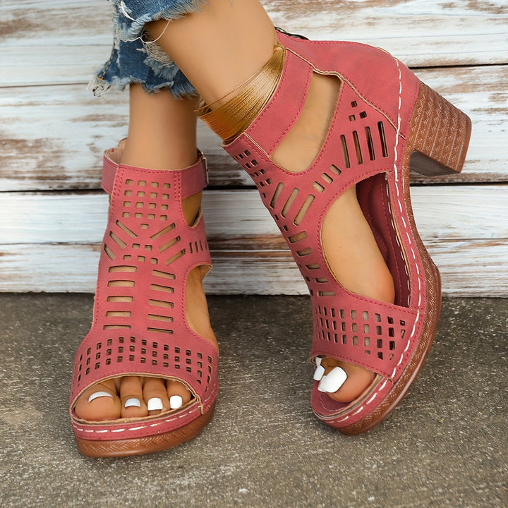 Pink ergonomic sandals close-up with perforated panels and ankle buckle strap