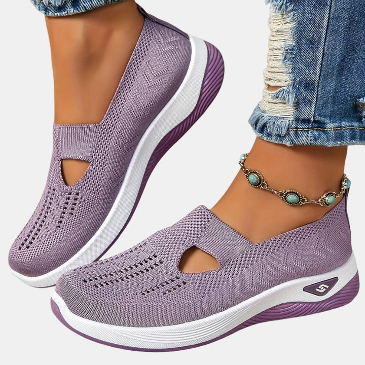Purple slip-on orthopedic walking shoe, knit upper with open toe cutouts, white sole.