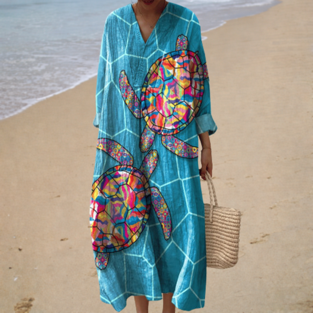 Teal printed summer dress with V-neck, loose sleeves, midi length and colorful graphic motifs