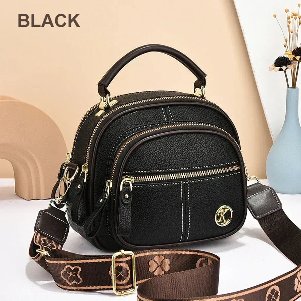 Mini chic crossbody shoulder bag in black with gold-tone hardware and zip compartments