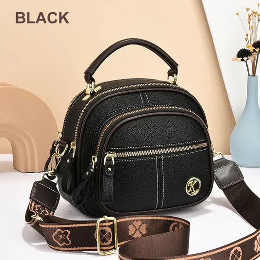 Mini chic crossbody shoulder bag in black with gold-tone hardware and zip compartments