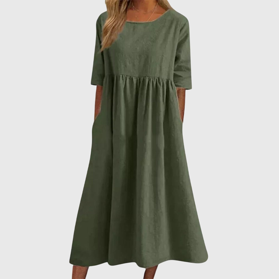 Dark green short-sleeve dress with round neck, gathered waist, and full midi skirt