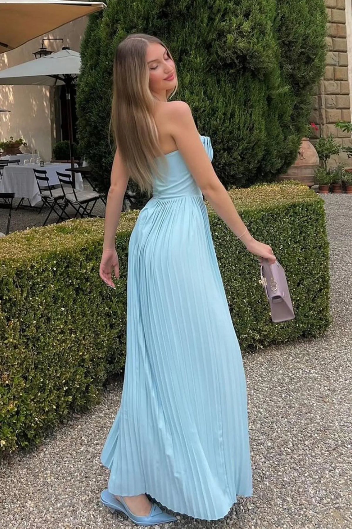 Light blue strapless maxi dress with structured sweetheart top and long pleated skirt