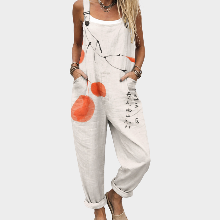Sleeveless printed overalls with orange graphic flowers, adjustable straps and front pocket