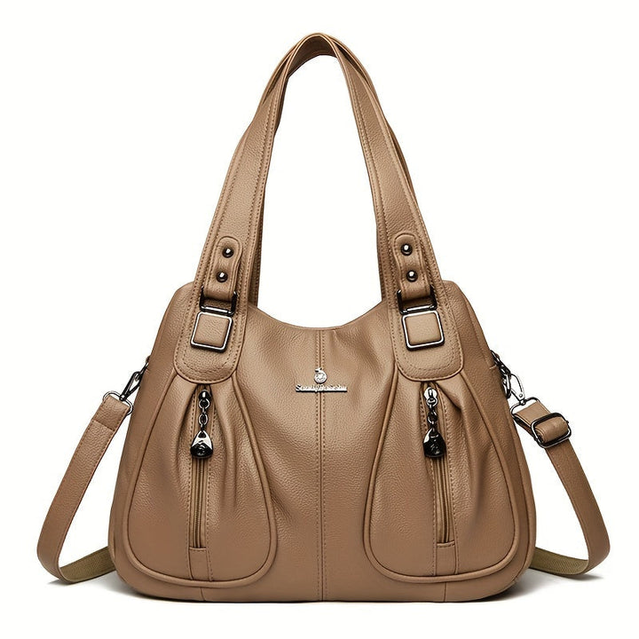 Women’s casual shoulder bag in beige with top handles and adjustable shoulder strap.