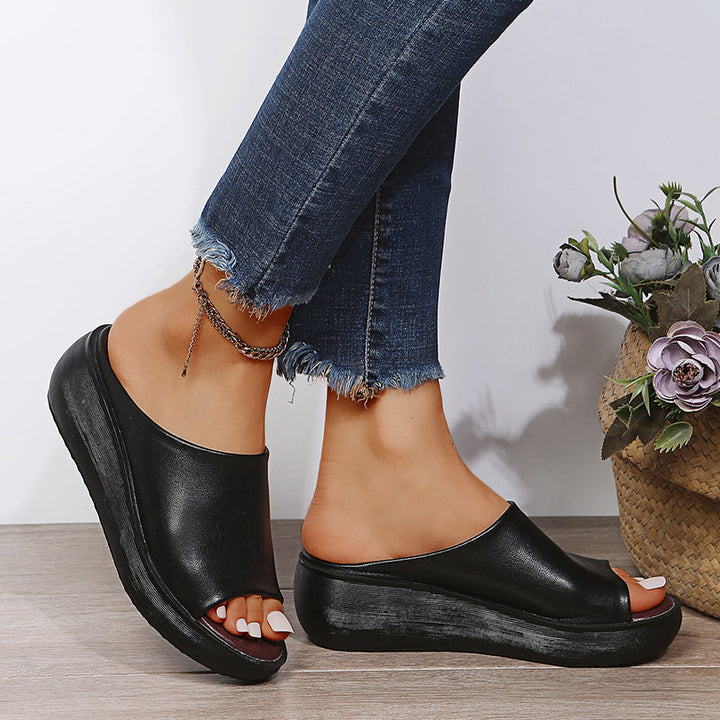 Black orthopedic slide sandals with wide open toe and thick platform sole