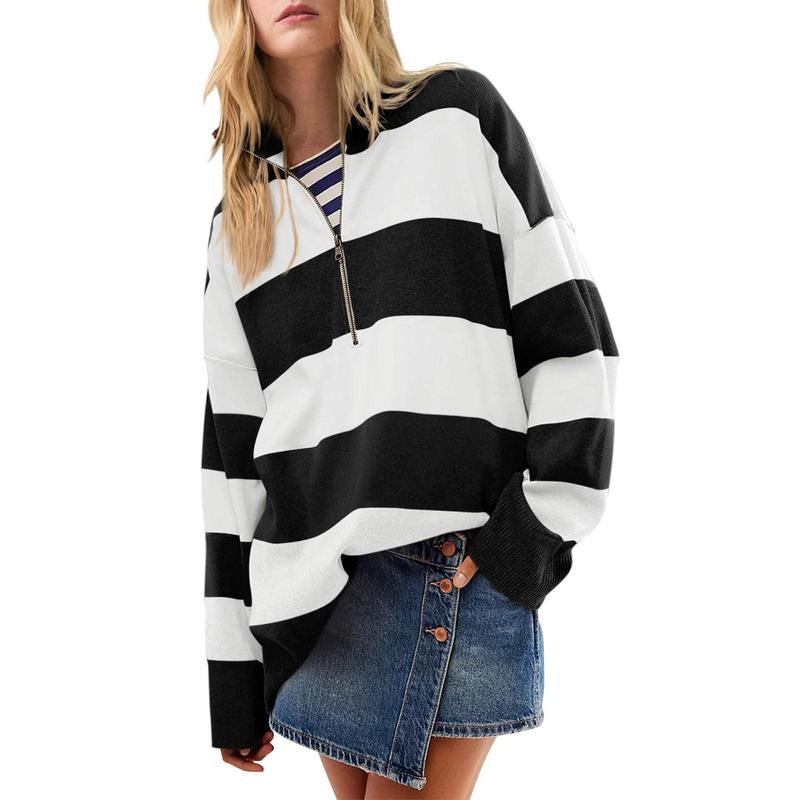 Oversized turtleneck sweater with black-and-white striped half-zip