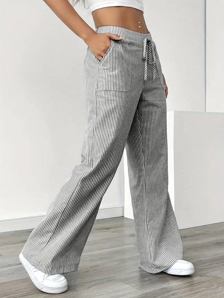 Striped wide-leg pants with tie drawstring and side pockets, black-and-white vertical stripes