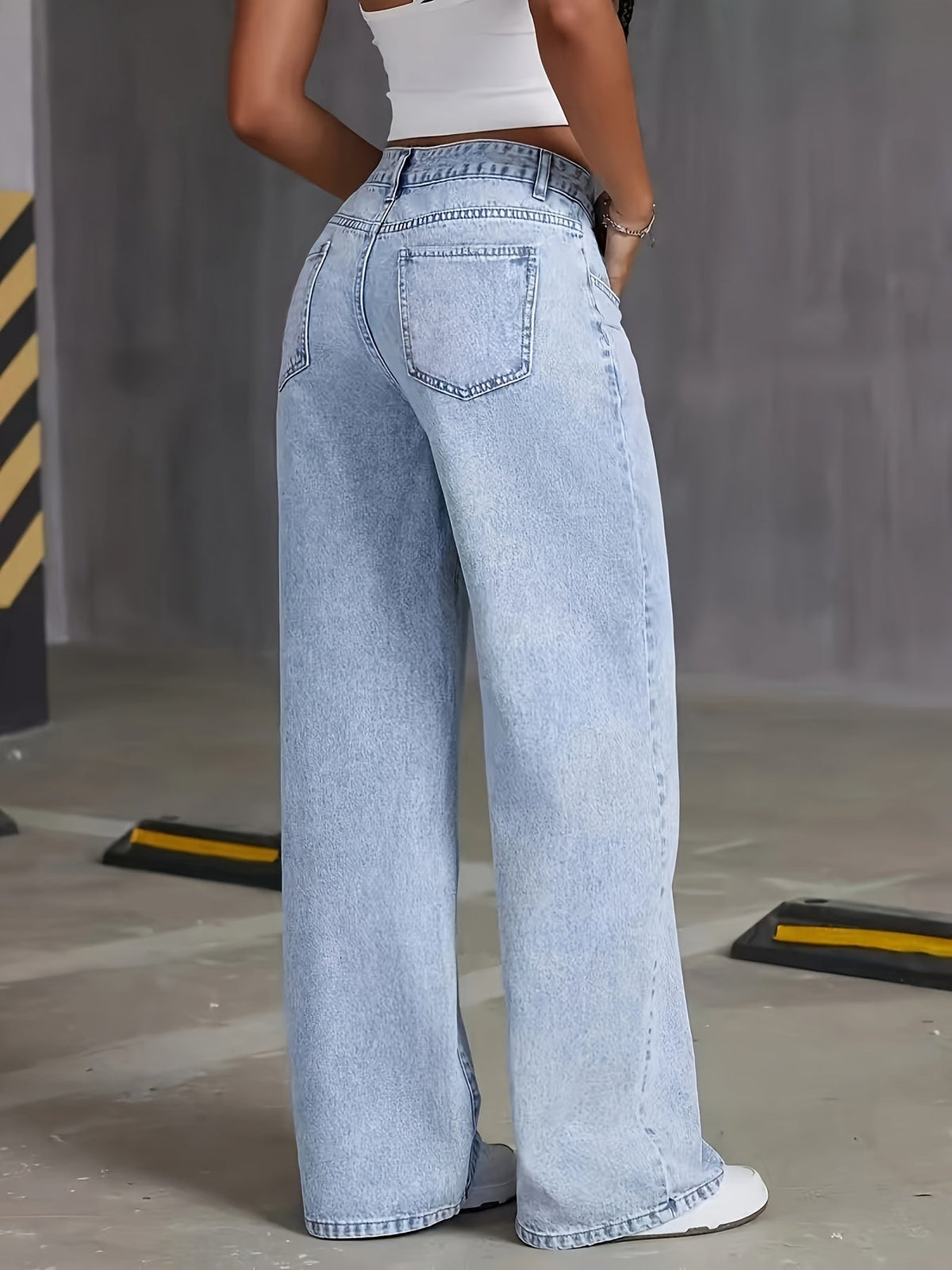 Light blue high-waisted wide-leg denim jeans with back patch pocket detail