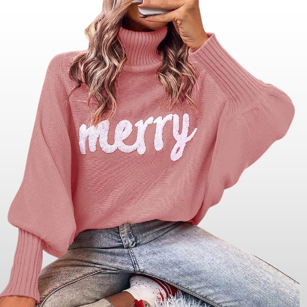 Dusty pink knit turtleneck sweater with batwing sleeves and white “Merry” print