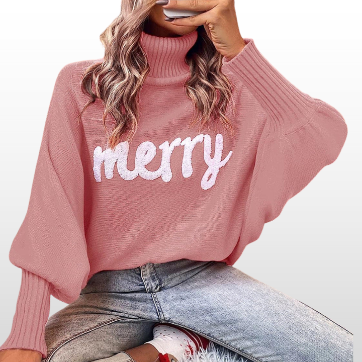 Dusty pink knit turtleneck sweater with batwing sleeves and white “Merry” print