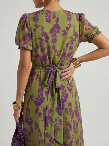 Floral midi dress back view with short puff sleeves and tied waist bow detail