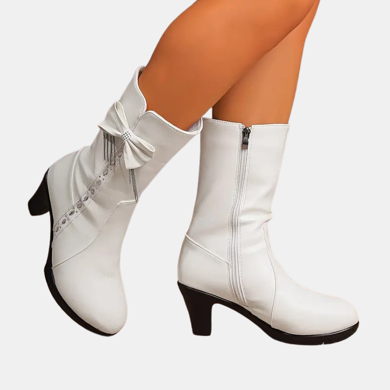 Vintage bow leather boots, white, side view with tall zipper and bow embellishment