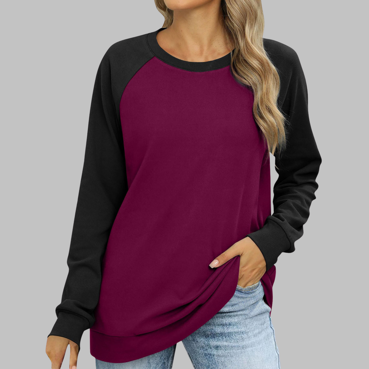 Two-tone raglan sweatshirt, round neck, long sleeves; maroon body, black sleeves