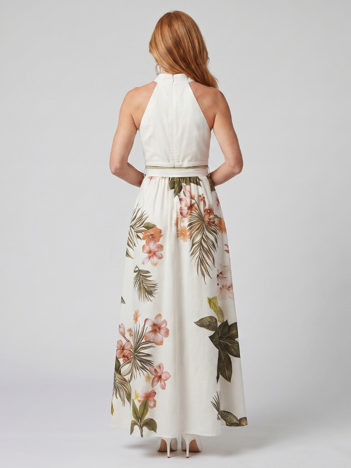 Back view: white halter maxi dress with open-back straps and floral botanical skirt
