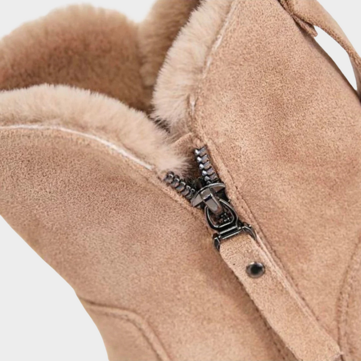 Beige suede comfort boot close-up with side zipper and soft faux-fur lining