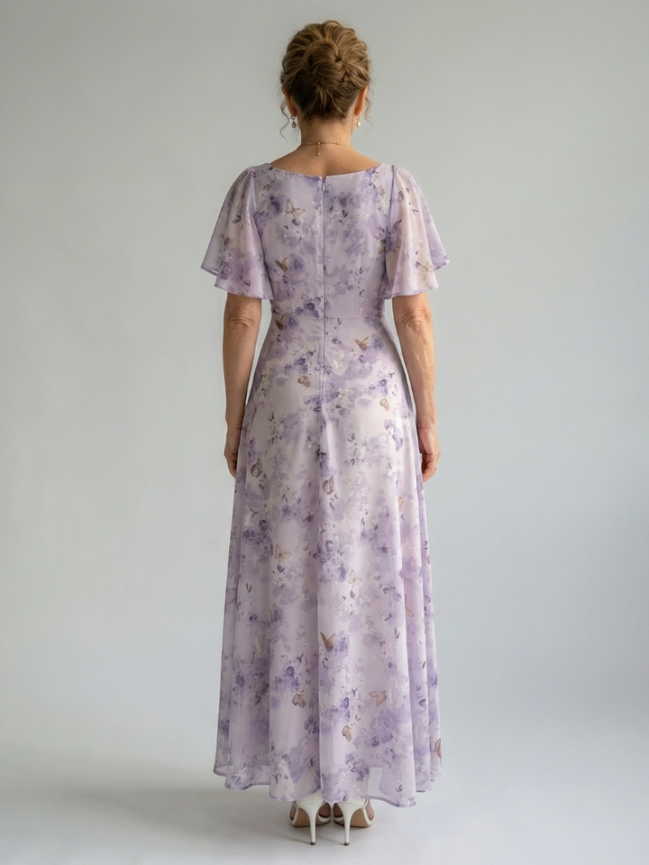 Back view of lavender floral midi dress with flutter sleeves and gathered waist seam