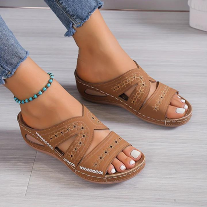 Orthopedic sandals with brown wide straps and open toe, stitched floral accents, cushioned sole