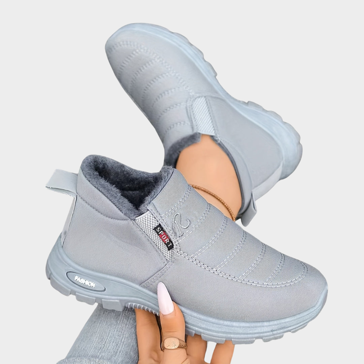 Light gray fur-lined ankle boots with elastic side and chunky sole