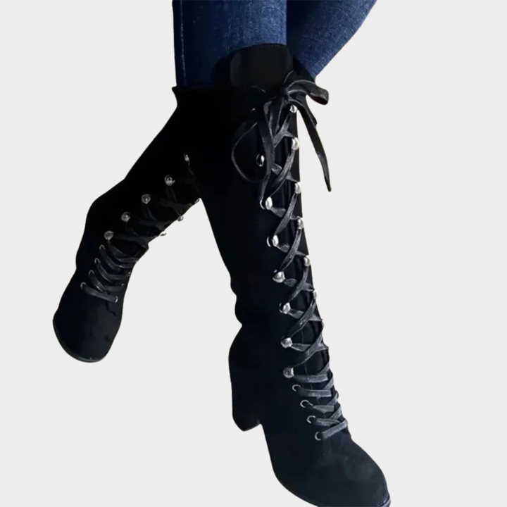 Black suede lace-up high heel boots with pointed toe and narrow block heel.