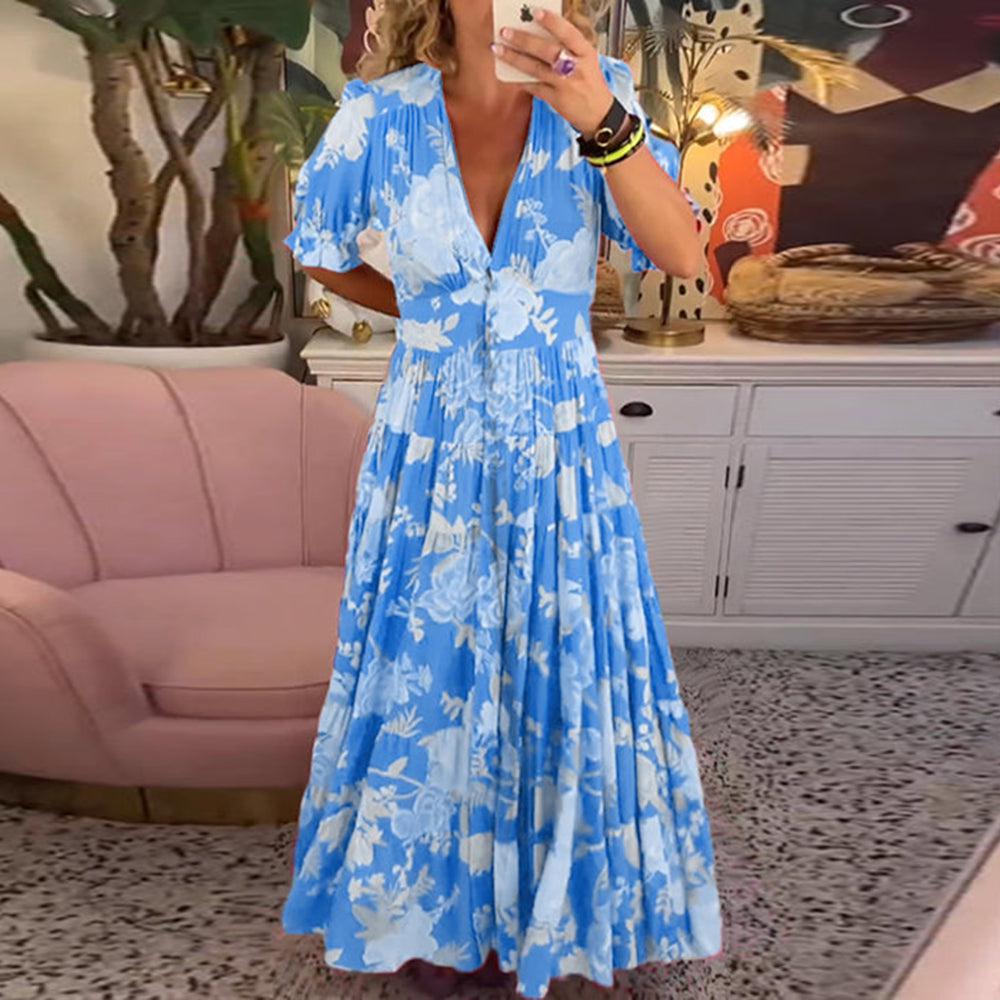 Floral maxi dress in blue with white flower print, V-neck, tiered skirt and puff sleeves