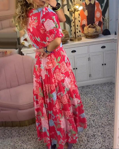 Floral maxi dress in red with pink and blue floral print, V-neck and pleated tiered skirt