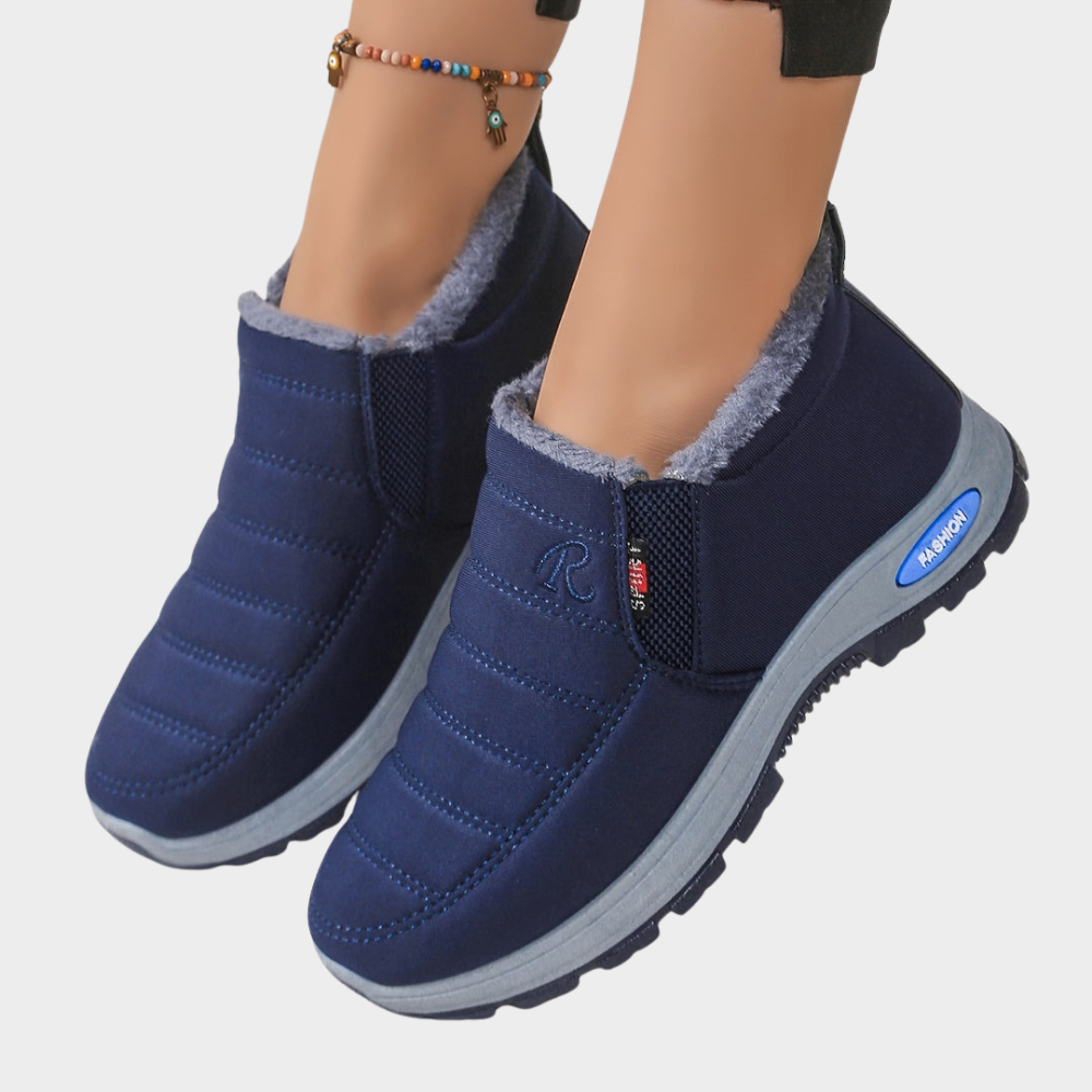 Navy fur-lined ankle boots with elastic side and chunky gray outsole