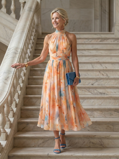 Soft halter midi dress with peach-and-blue watercolor print, gathered high neck, full skirt