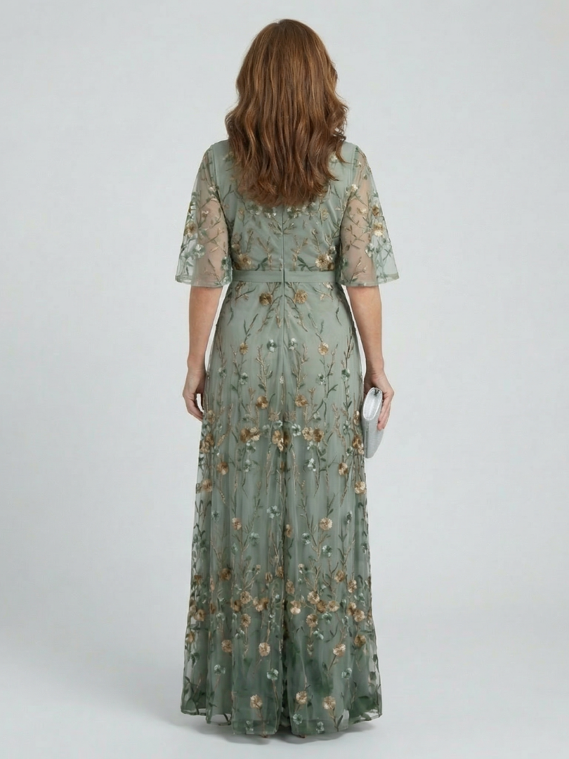 Back of sage green floral maxi dress with V-neck styling, waist tie, short sleeves
