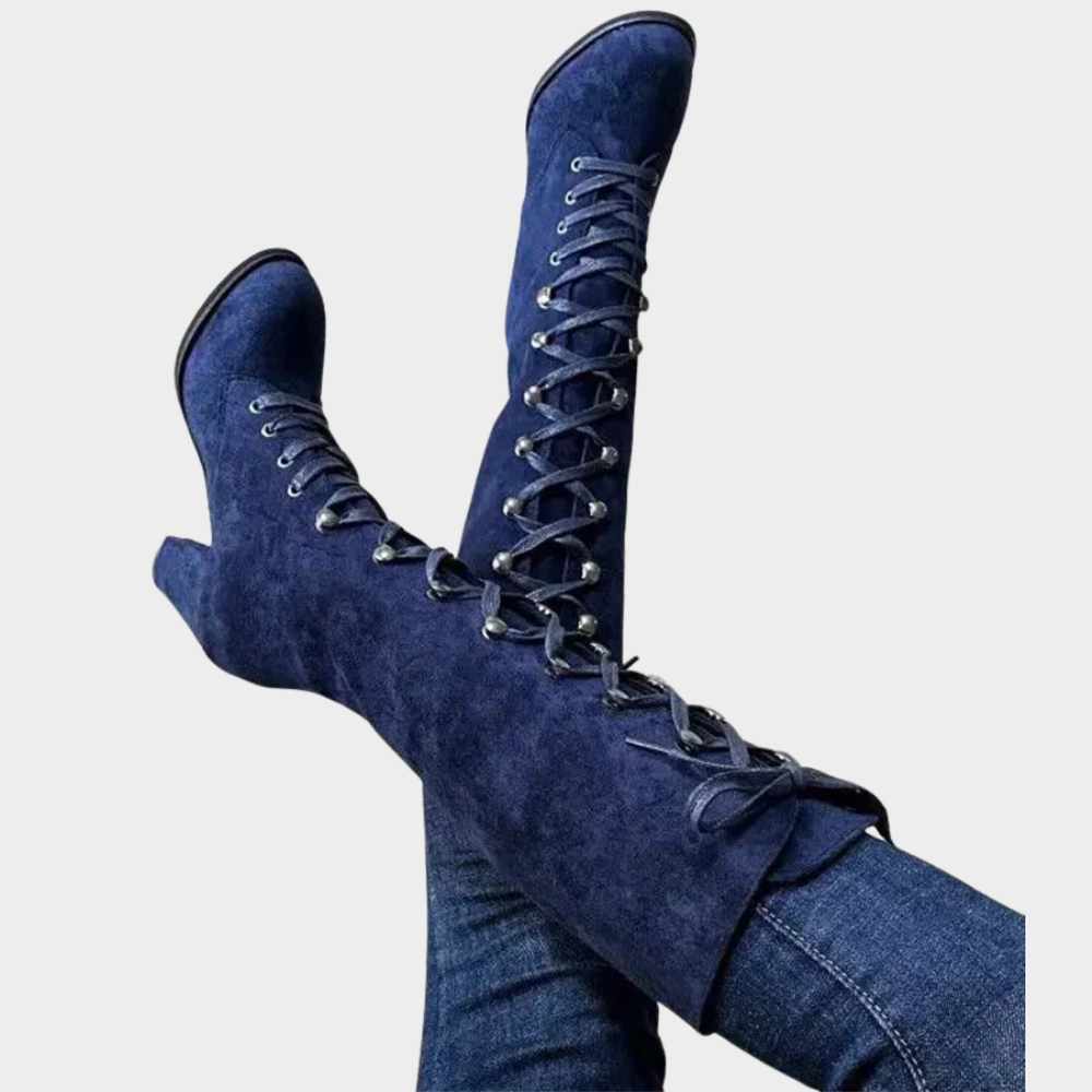 Blue suede lace-up high heel boots with long laces and pointed toe.
