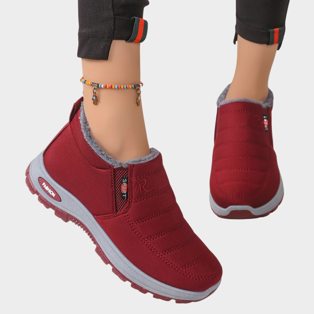Burgundy fur-lined ankle boots with elastic side and chunky gray outsole