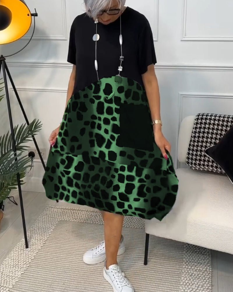Women’s midi dress with black top and green leopard-print skirt, flowing A-line