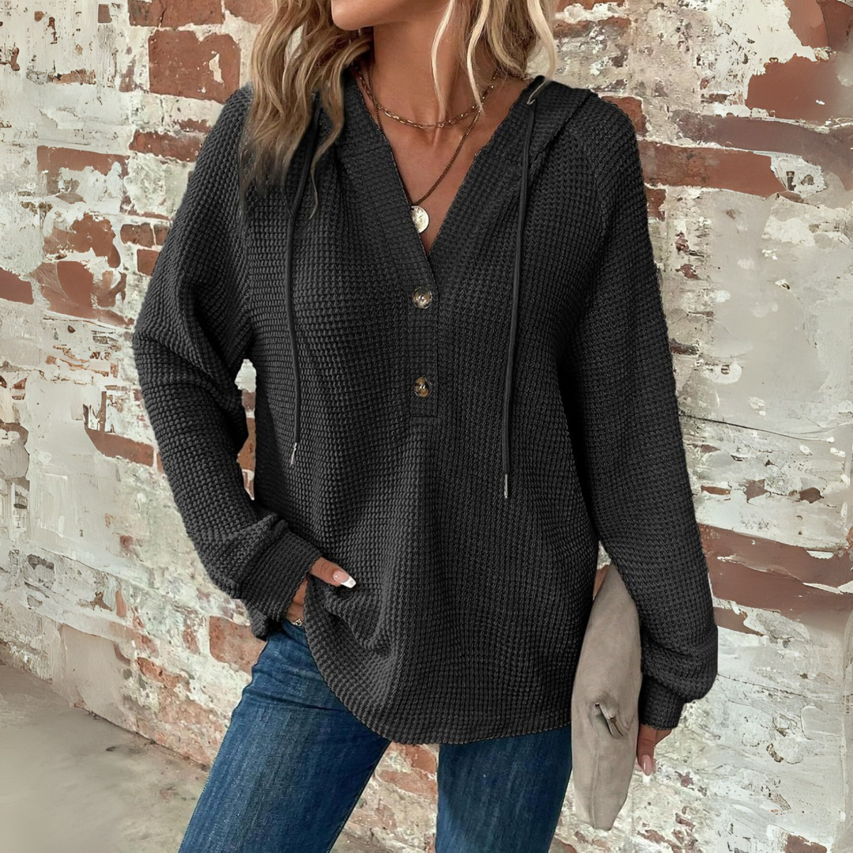 Black waffle-knit hoodie with V-neck and button placket, long sleeves
