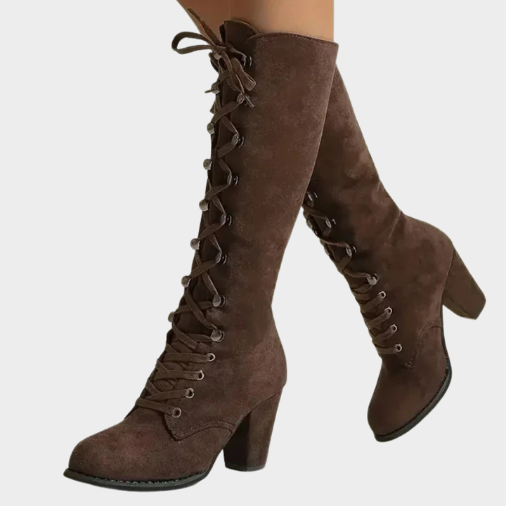 Brown suede lace-up high heel boots with pointed toe and stacked block heel.