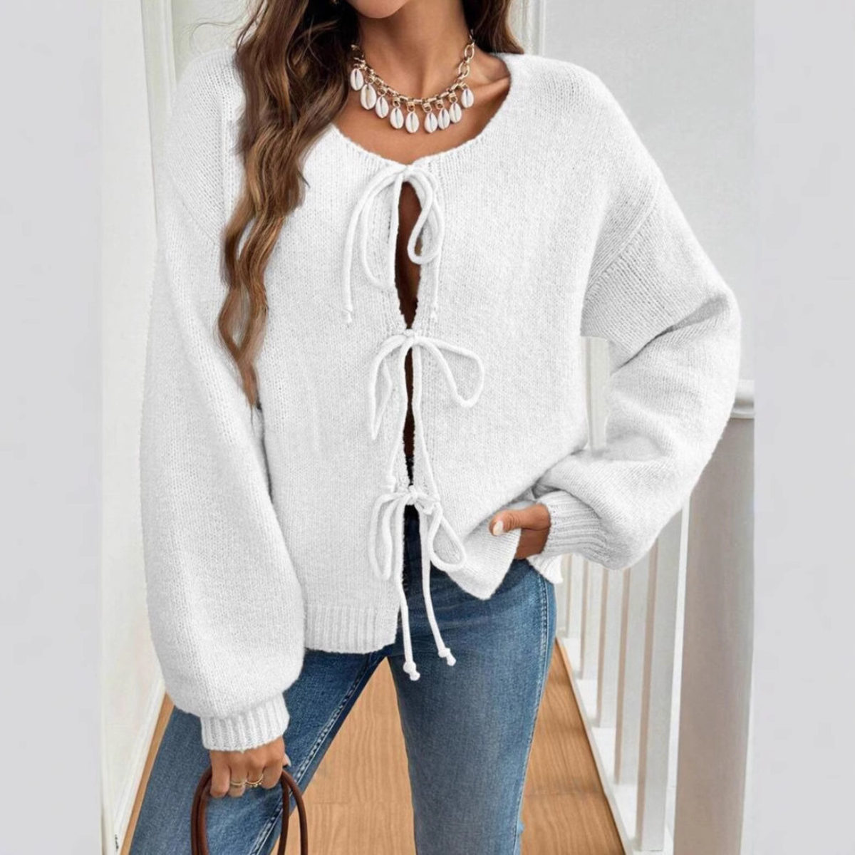 White tie-front cardigan with round neck and drawstring lacing, long sleeves